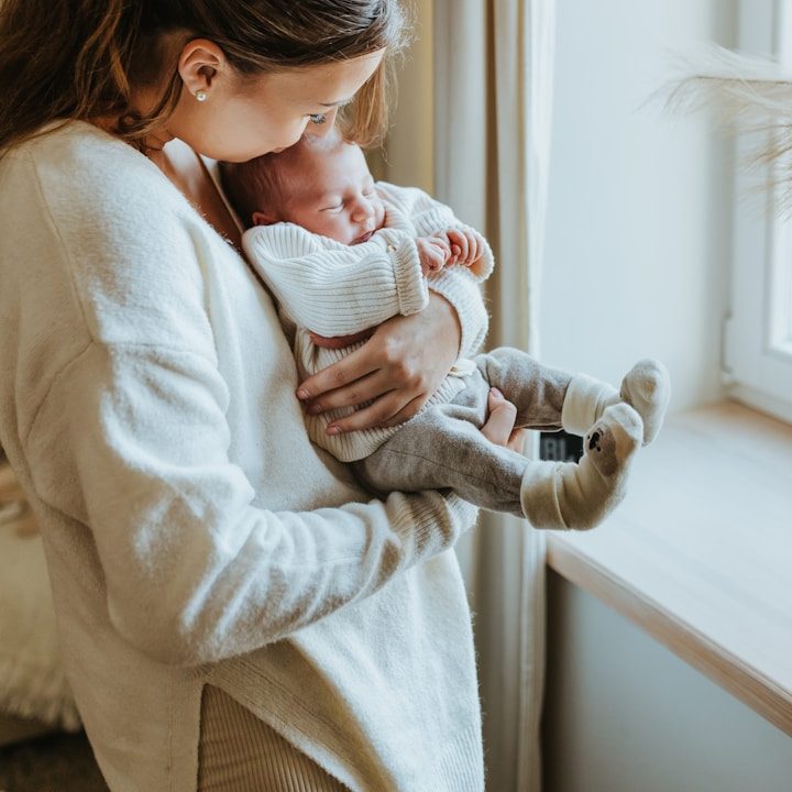 Newborn baby being held by mother Newborn baby being held by mother